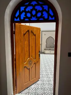 Une porte de bois sous un vitrail bleu